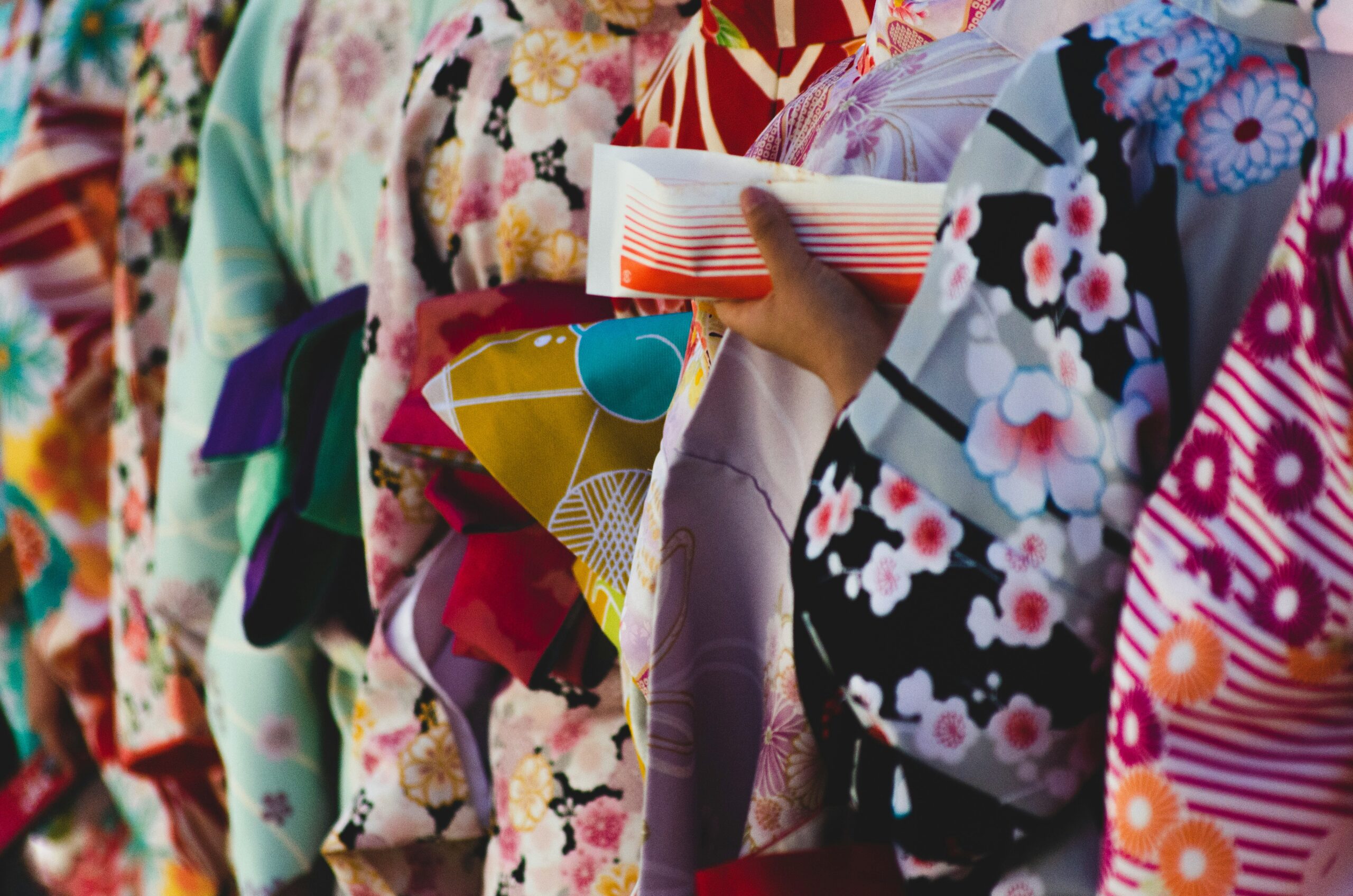 Close-up of colorful kimono fabrics showing intricate floral and geometric designs in various patterns highlighting the artistry of traditional kimono textiles