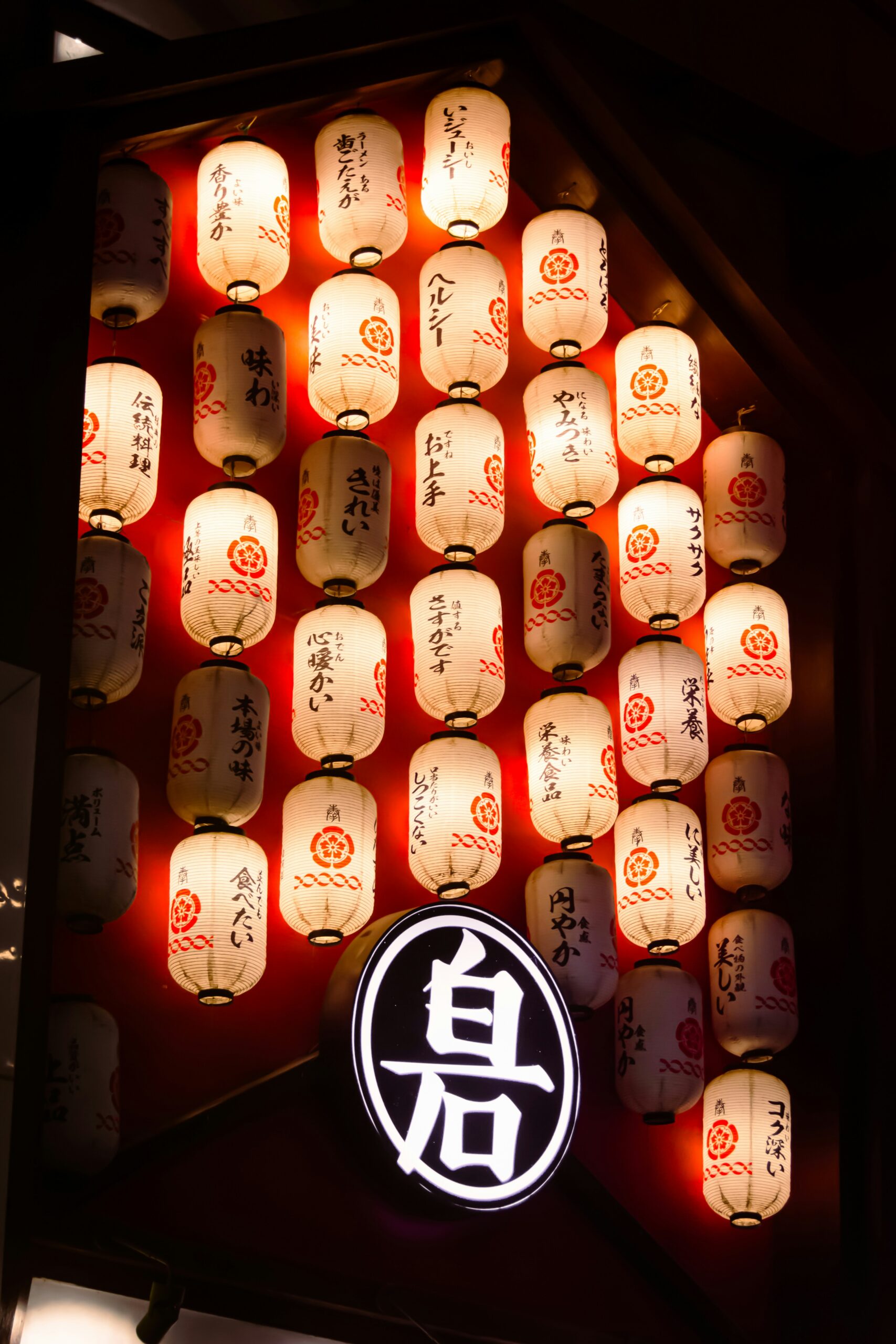 Festival float with traditional paper lanterns illuminated at night with a crowd of spectators