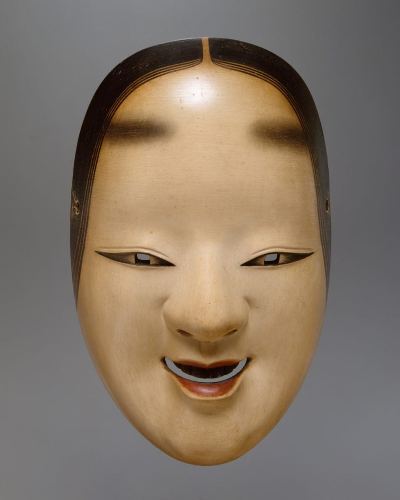 Ko-omote mask used in Noh drama, showcasing the influence of traditional theatrical elements on contemporary design