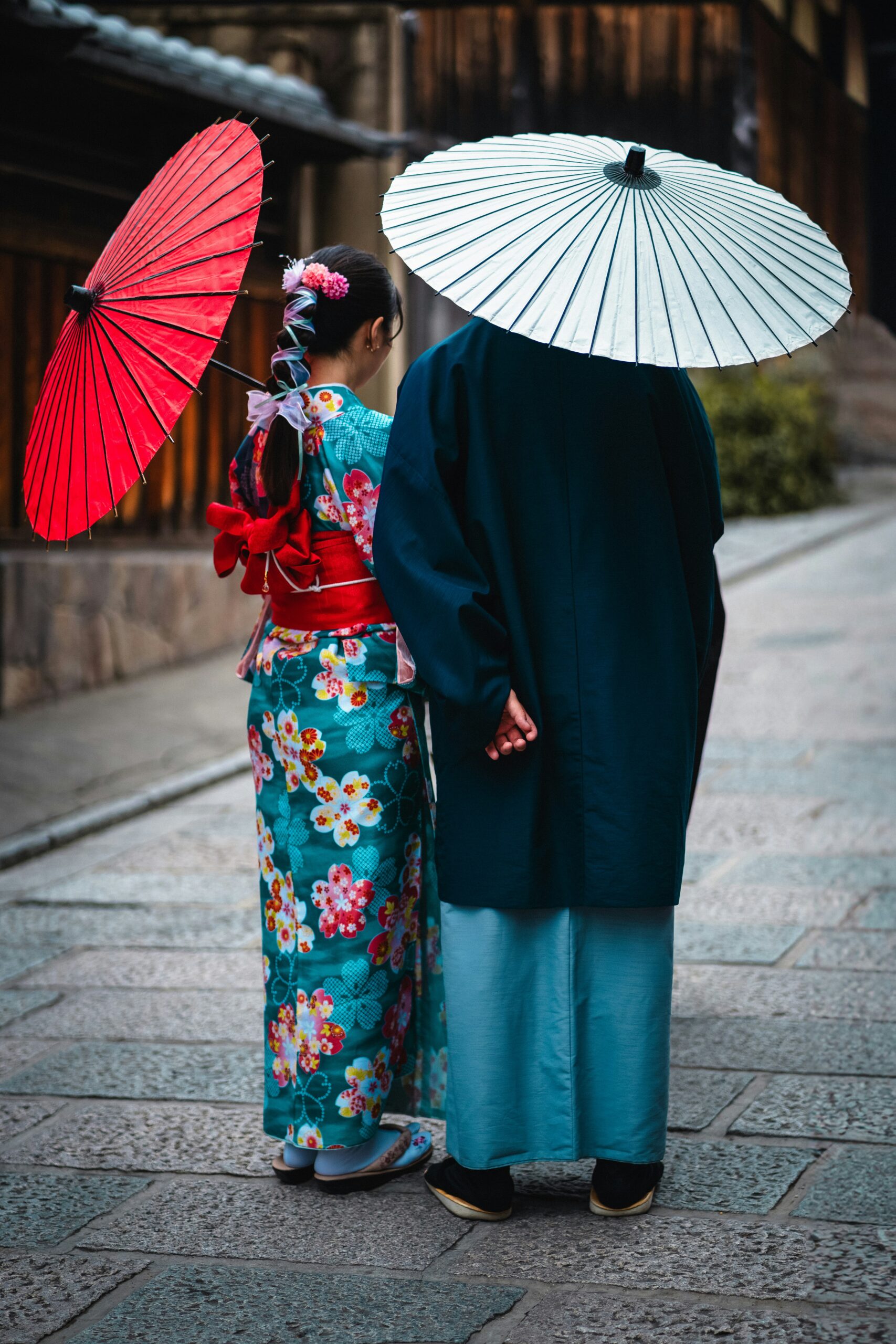 Traditional women in elegant kimono walking through historic Kyoto streets, showcasing the timeless beauty of Japanese cultural heritage