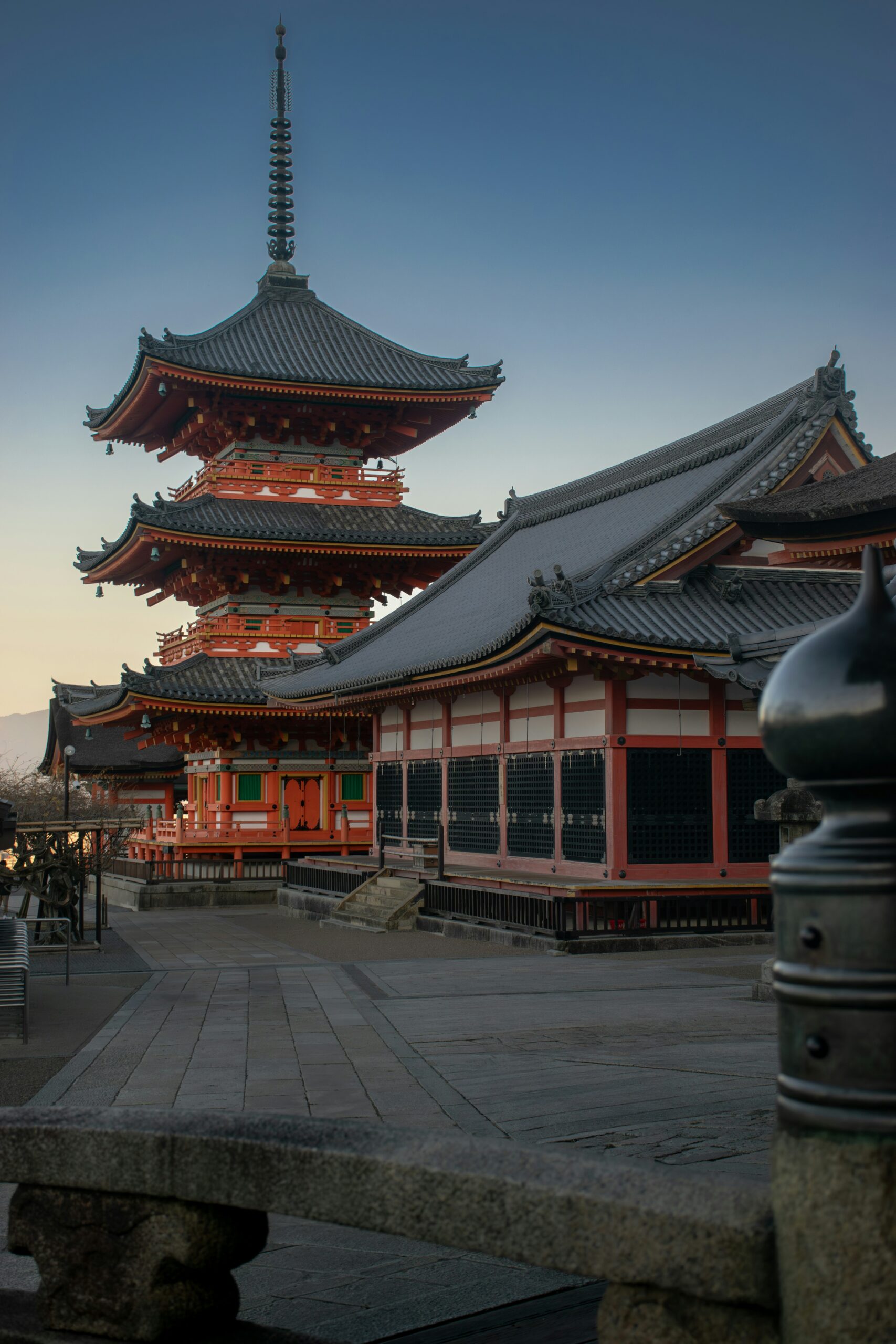 Traditional Japanese temple architecture with pagoda and curved roofs, showcasing iconic Kyoto temple locations for cultural photography