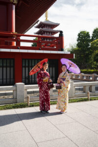 Yasaka shrine vermillion torii gate entrance in Kyoto with traditional red wooden lanterns and stone pathway