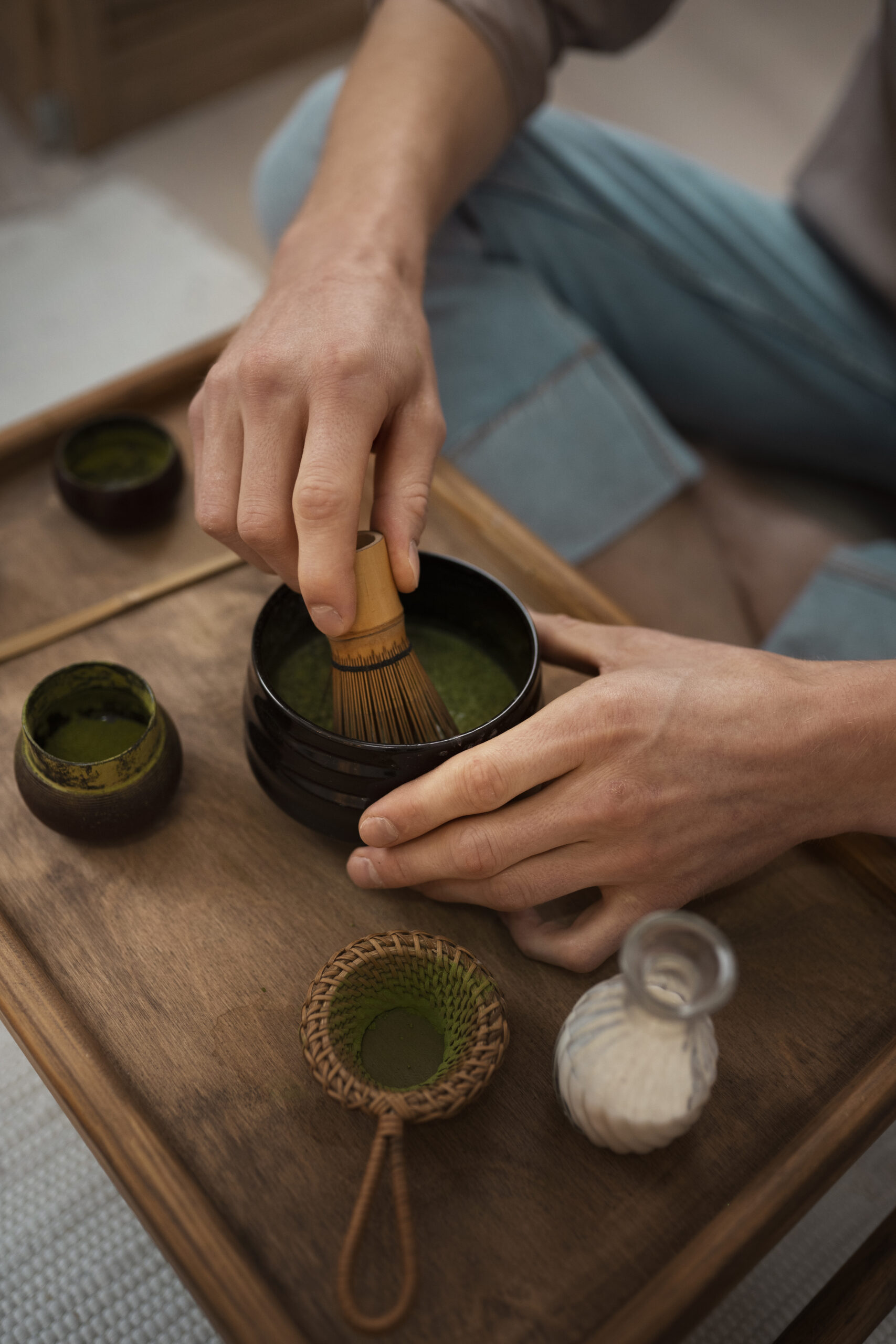 Traditional Japanese tea ceremony experience with women in kimono preparing and serving matcha in authentic setting