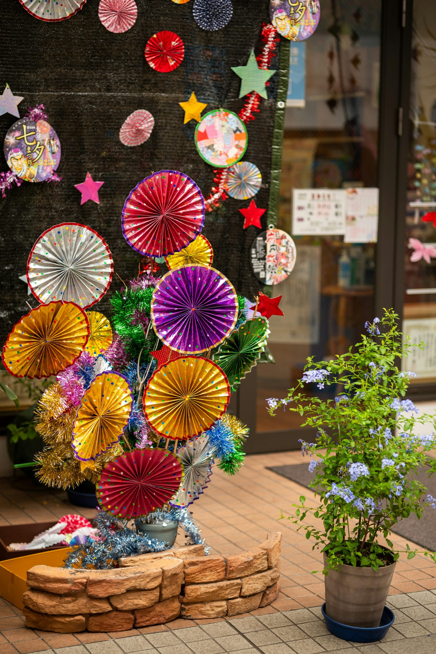 Colorful Japanese festival decorations with paper fans and stars creating vibrant celebration atmosphere perfect for summer yukata experiences