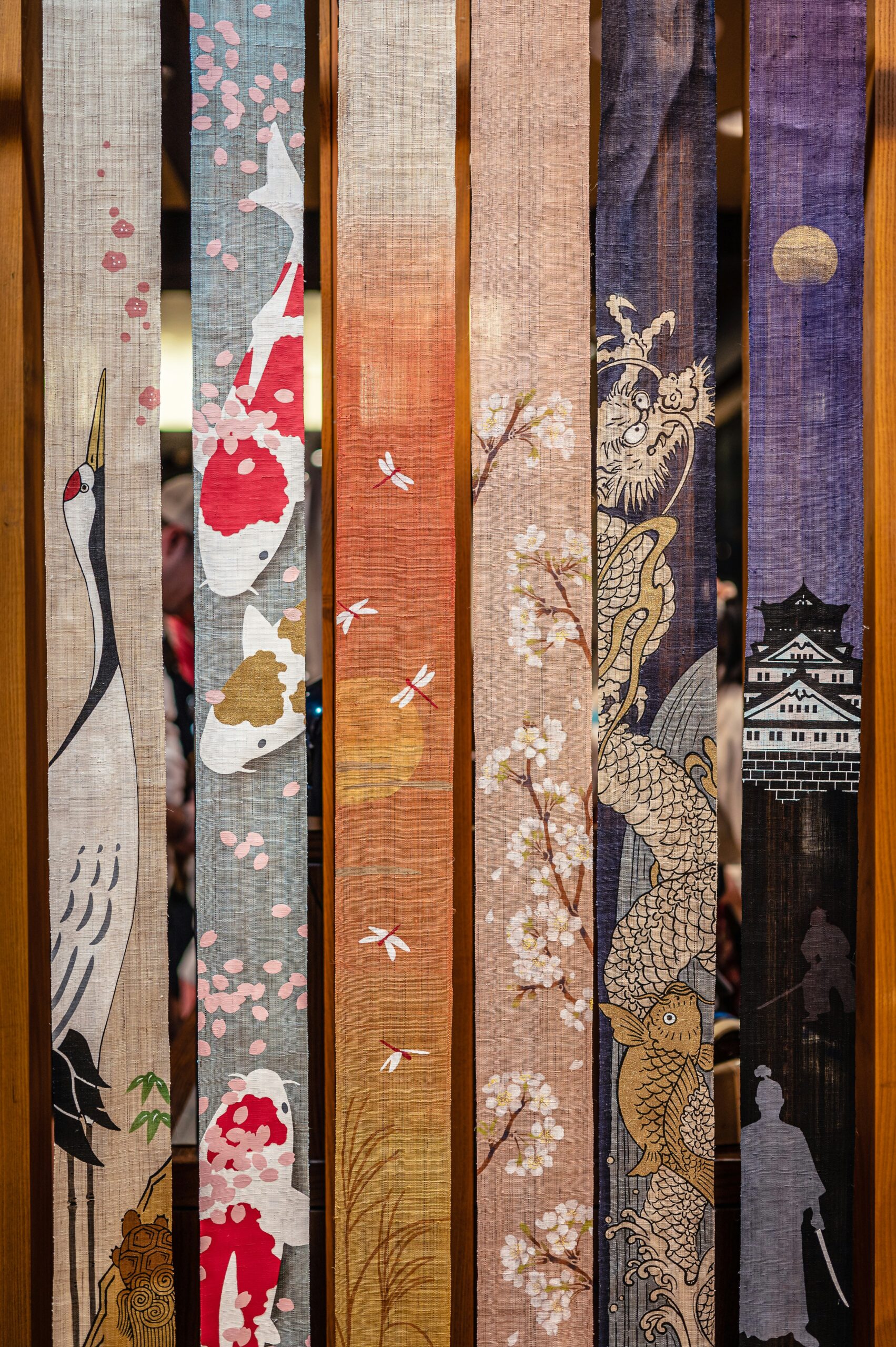Traditional Kyoto Yuzen dyeing process showing intricate hand-painted silk fabric with delicate floral patterns in vibrant colors, demonstrating the meticulous craftsmanship that transforms Nihonga art into wearable kimono designs