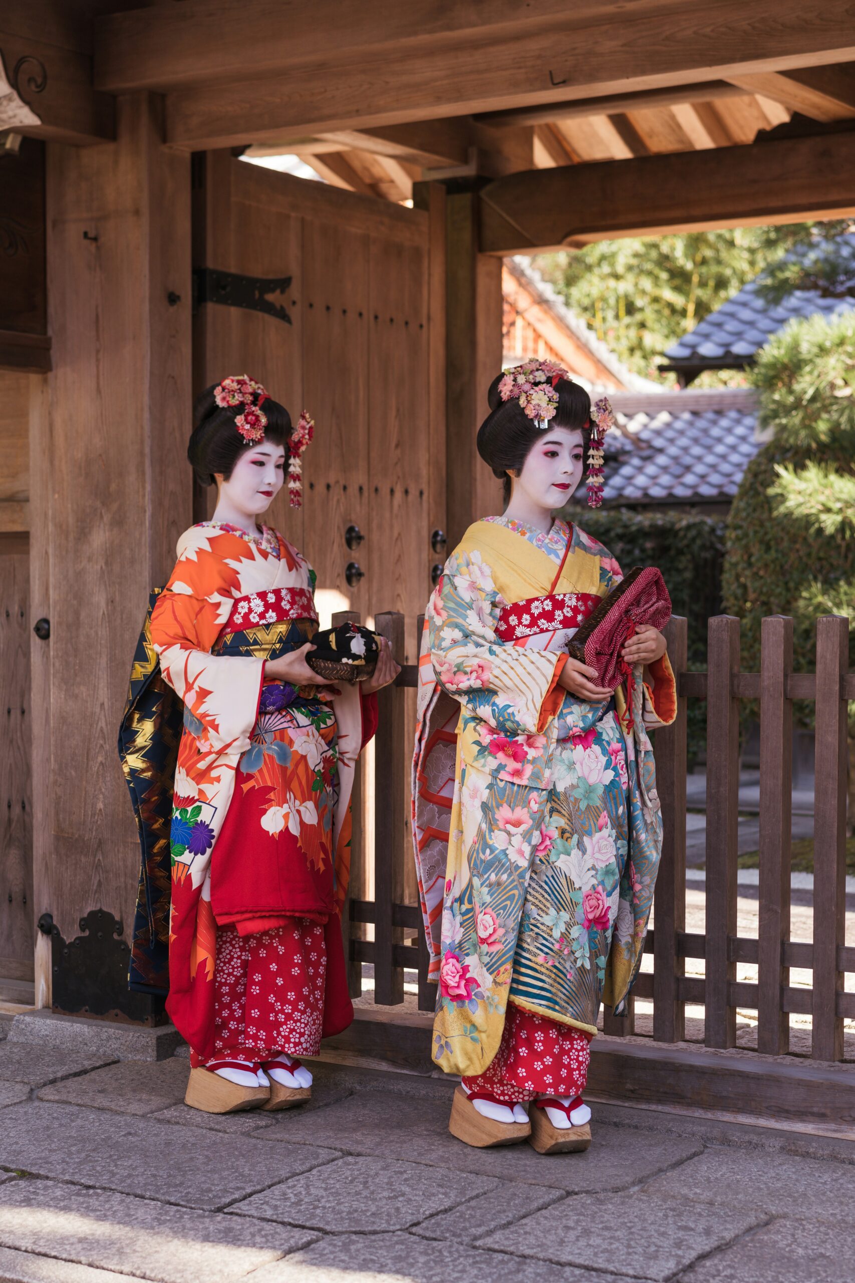 Elegant Geiko in traditional kimono walking through historic Kyoto streets, showcasing the refined beauty of Japanese traditional culture