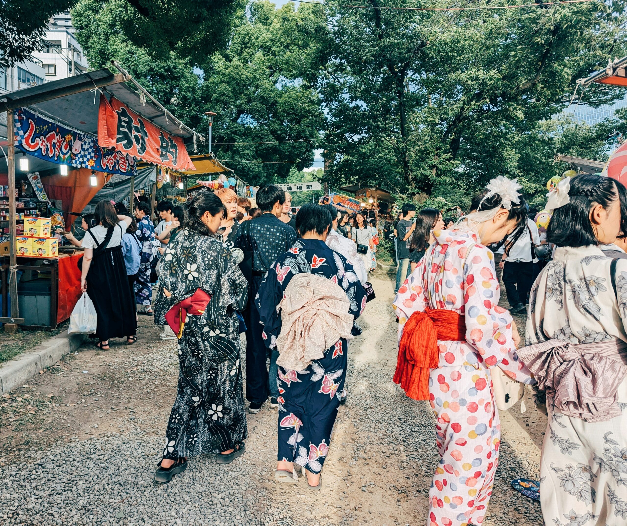 Modern tourists enjoying kimono rental experience in Kyoto temple district combining traditional Japanese culture with contemporary tourism