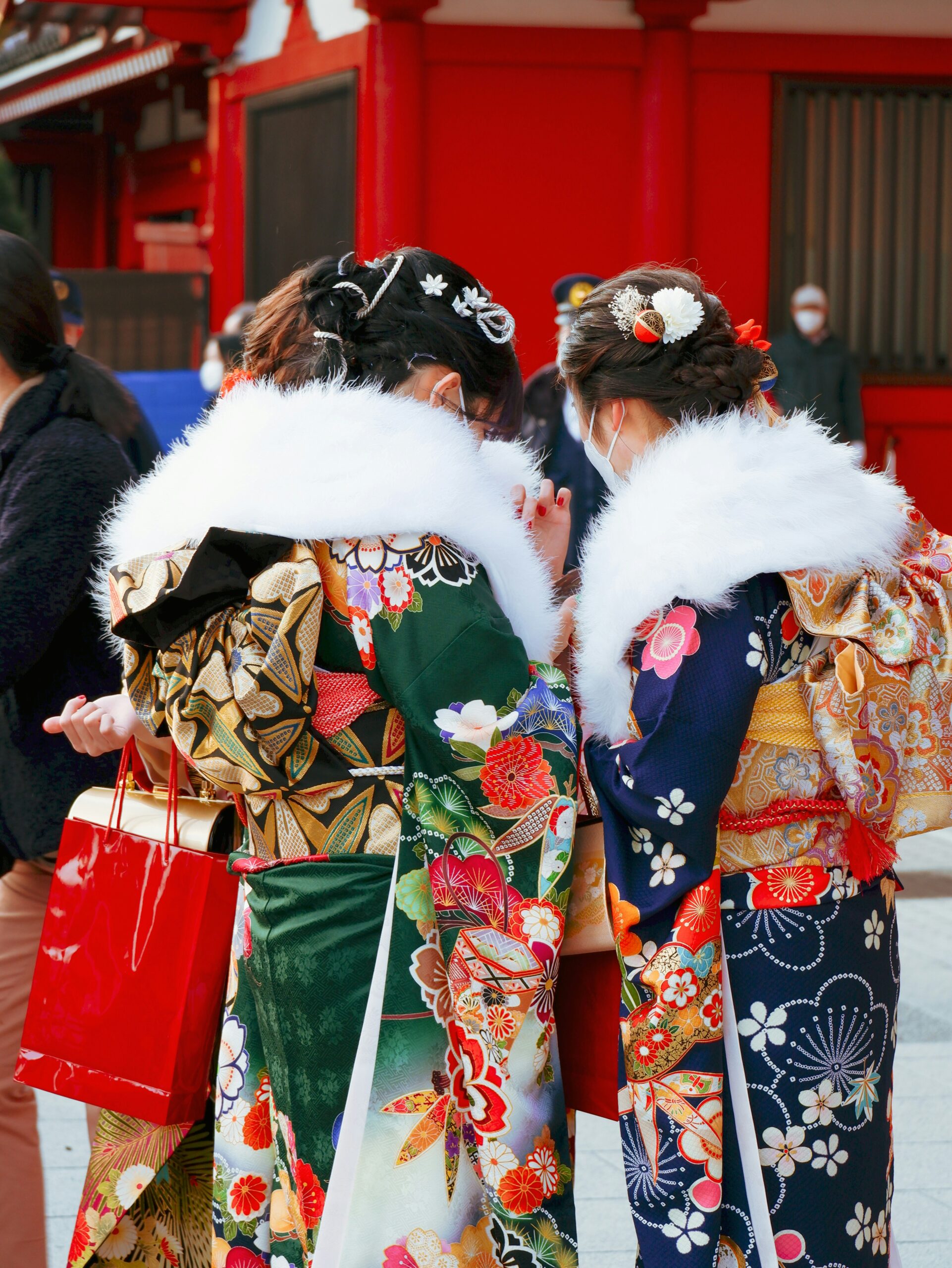 Arashiyama kimono rental experience in Kyoto showing visitors wearing traditional kimono with mythical patterns among bamboo forest scenery