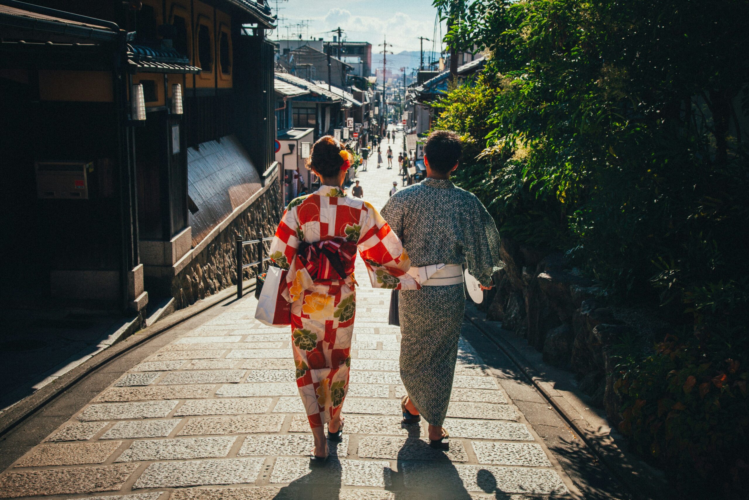 Woman in elegant kimono standing on traditional Higashiyama district street in Kyoto showcasing Japanese cultural heritage