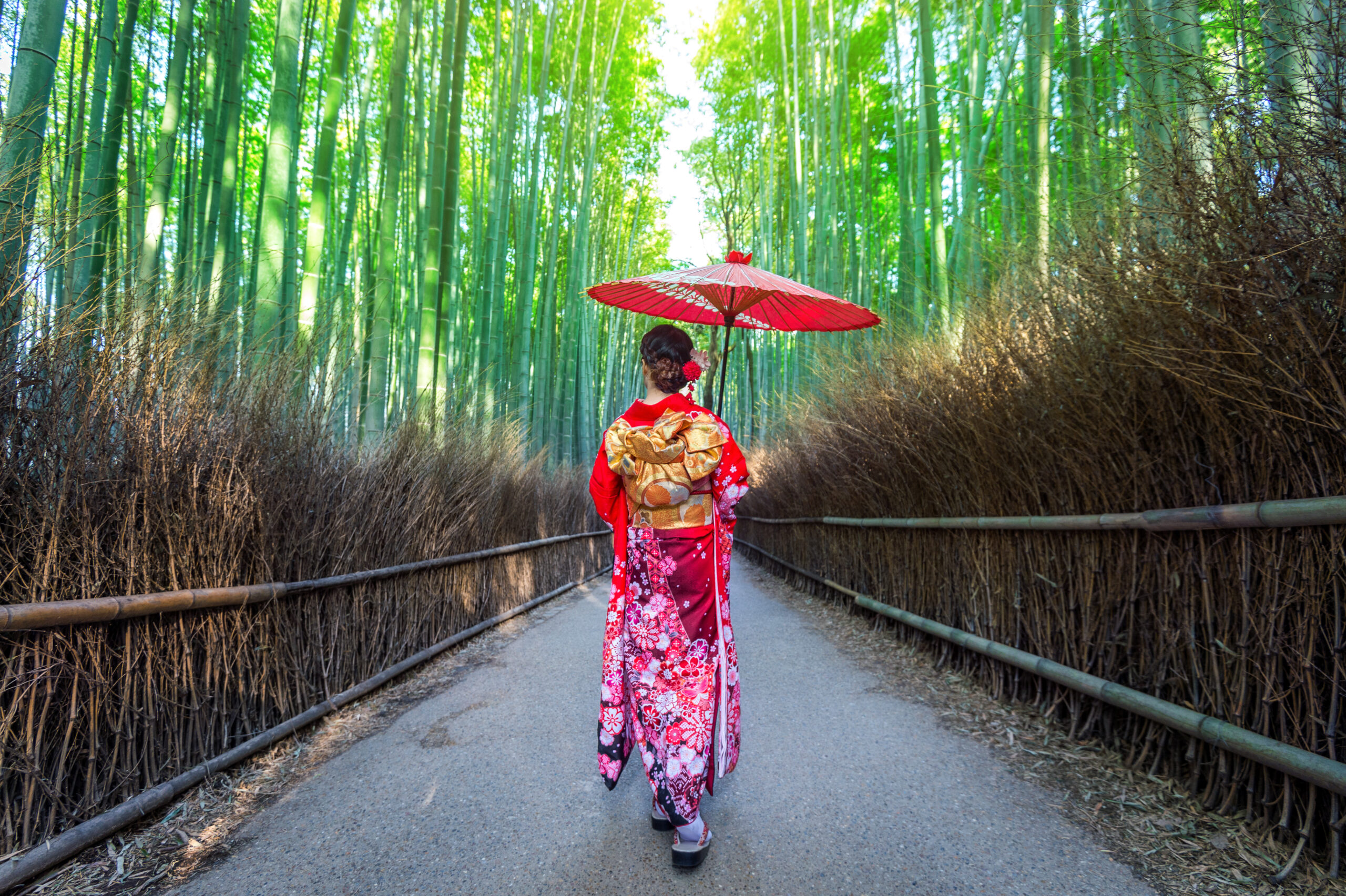 Asian woman wearing traditional Japanese kimono posing in front of the iconic Yasaka Pagoda on Sannenzaka street in Kyoto's historic Higashiyama district