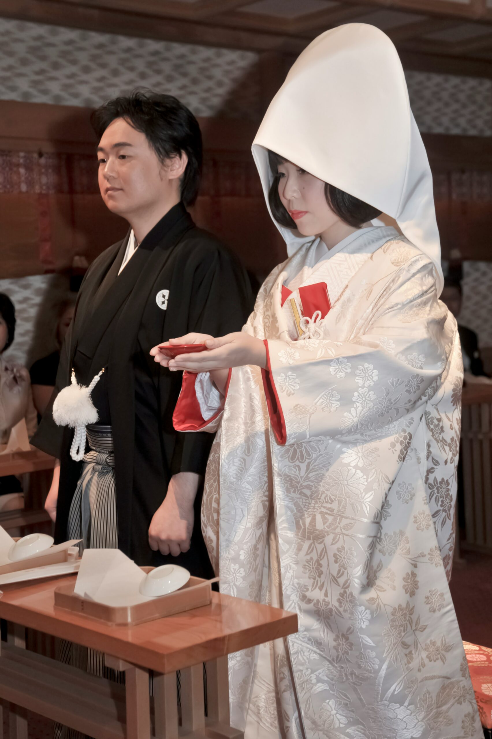 日本新娘穿着传统婚礼和服，礼服上绣有优雅的家族徽章（家纹），展现文化遗产