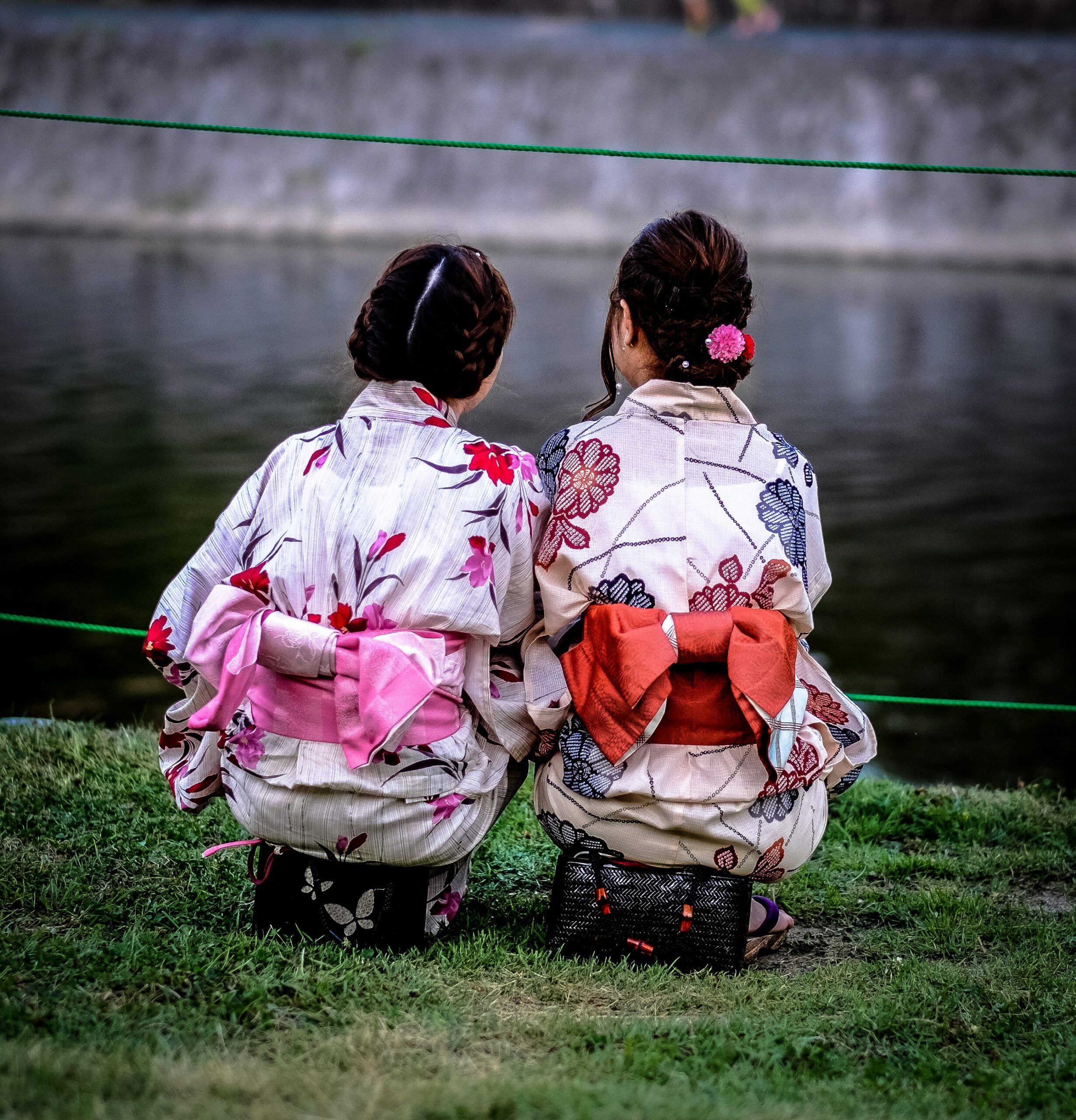 Detailed view of traditional Japanese kimono showing intricate obi sash patterns and elegant fabric designs from behind