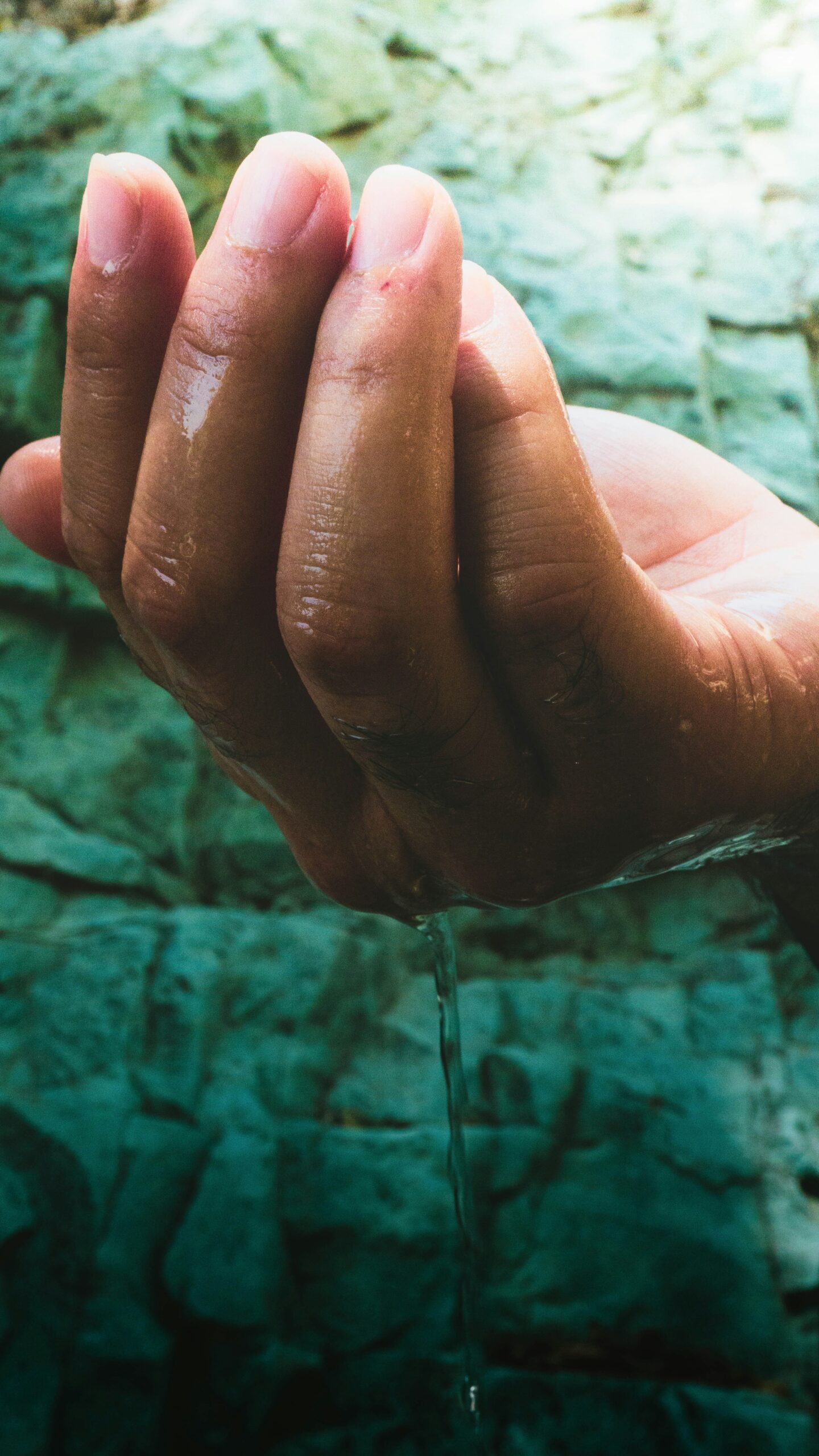 Traditional Japanese purification ritual at shrine temizuya water basin, showing proper hand and mouth cleansing ceremony before prayers