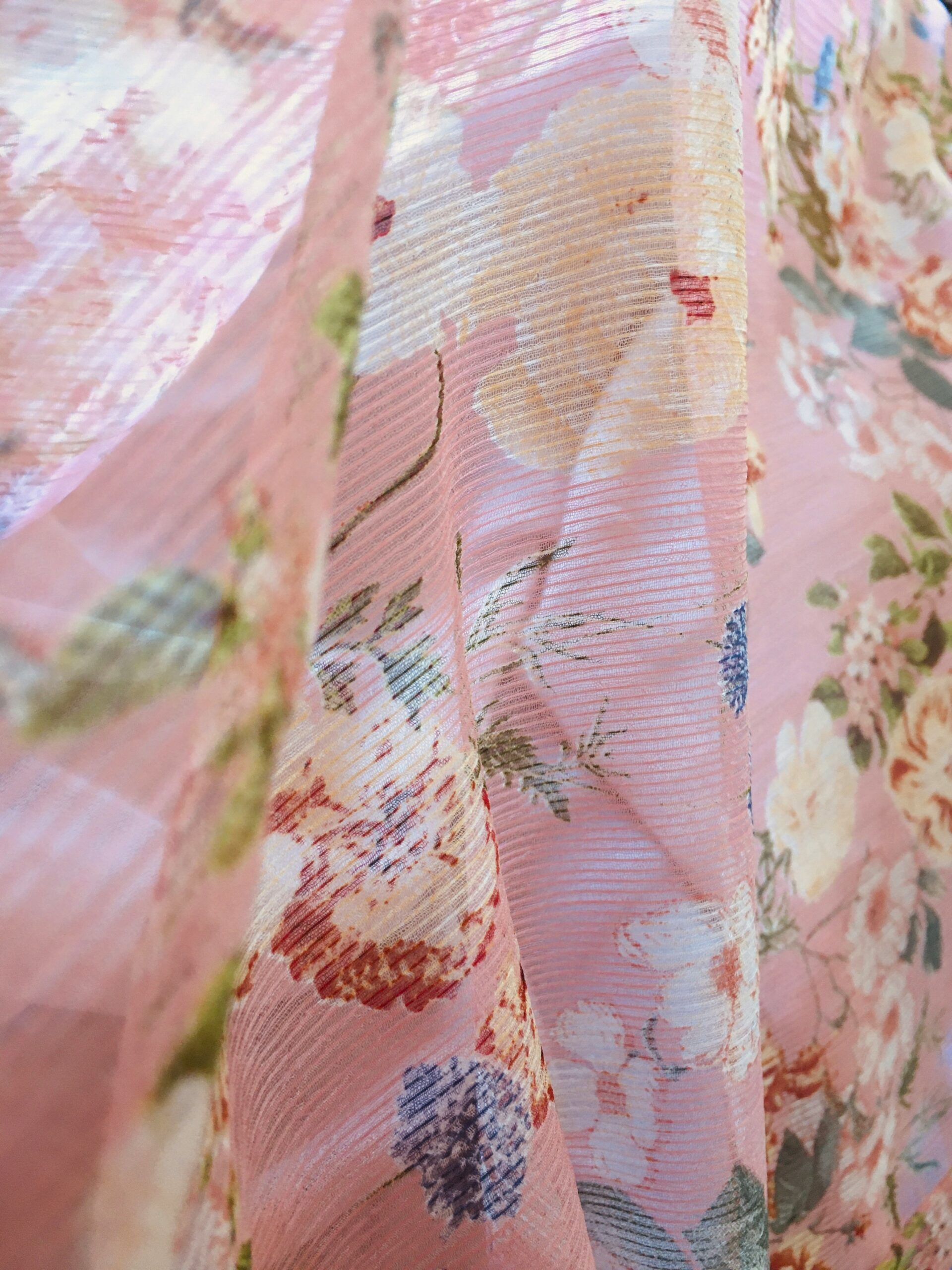 Detailed view of traditional kimono silk fabric with intricate floral patterns and seasonal motifs