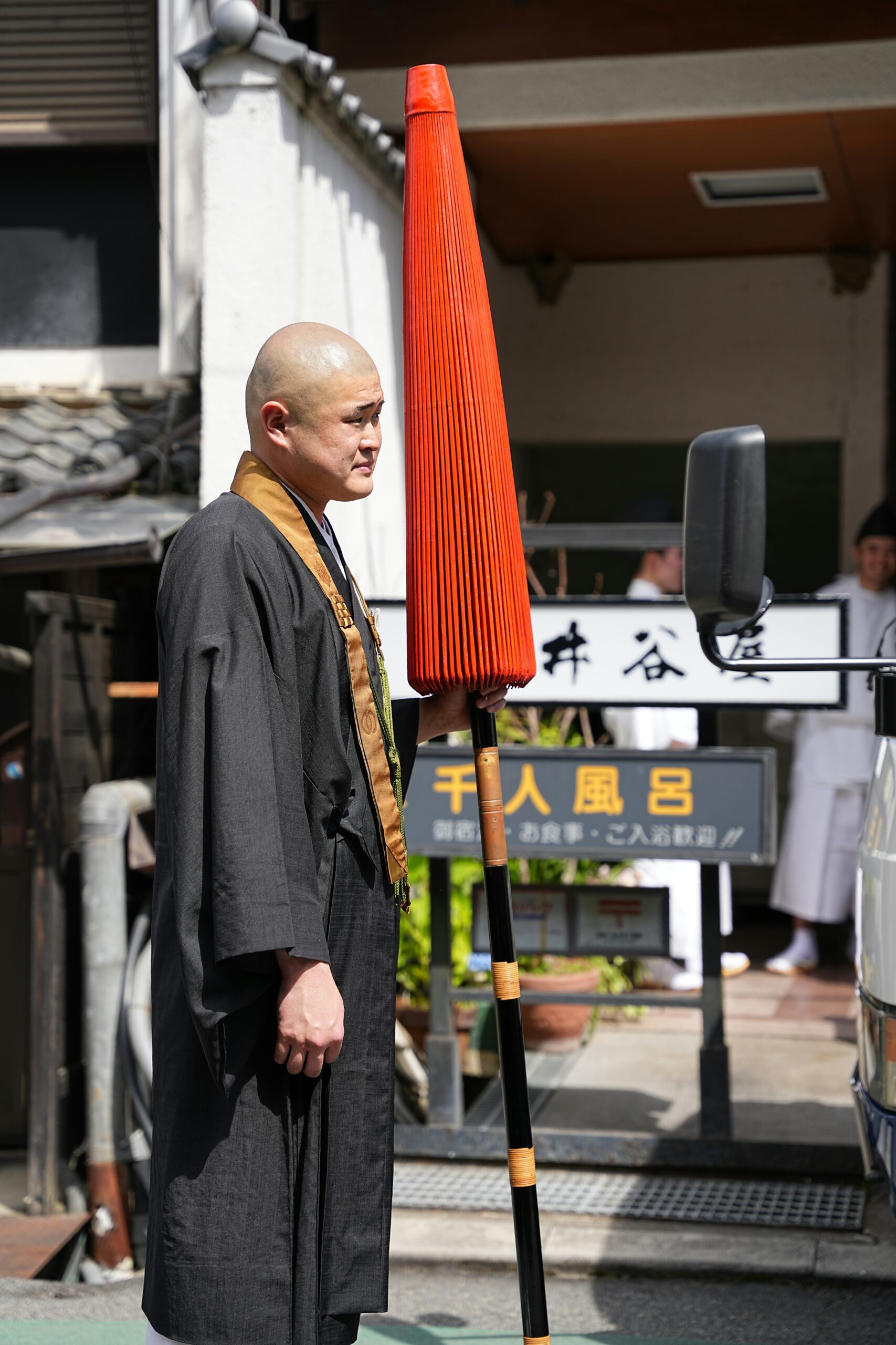 Fushimi Inari Taisha harvest ceremony with Shinto priests in white robes and participants in traditional kimono offering rice to Inari deity during agricultural festival