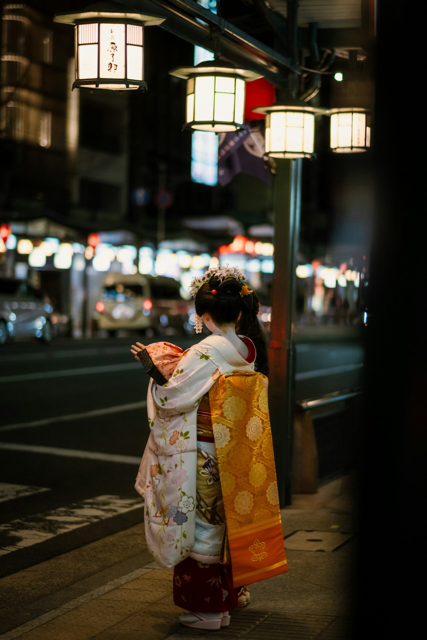 Two women in traditional kimono walking through historic Gion district streets in Kyoto Japan