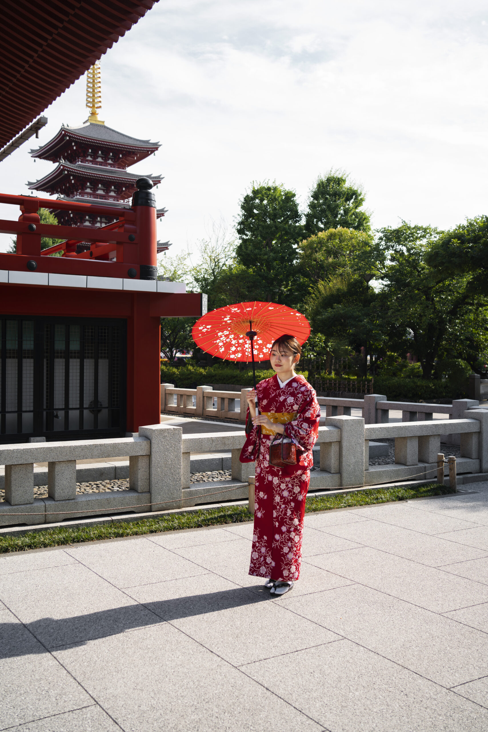 Women wearing traditional yukata summer kimono enjoying festival atmosphere in Kyoto with traditional Japanese architecture background
