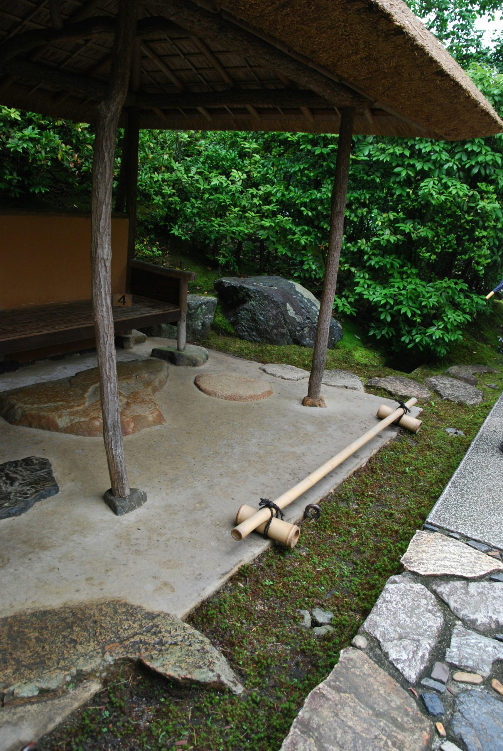 Traditional Japanese onsen outdoor hot spring bath with natural rock formations and steam rising from mineral-rich waters