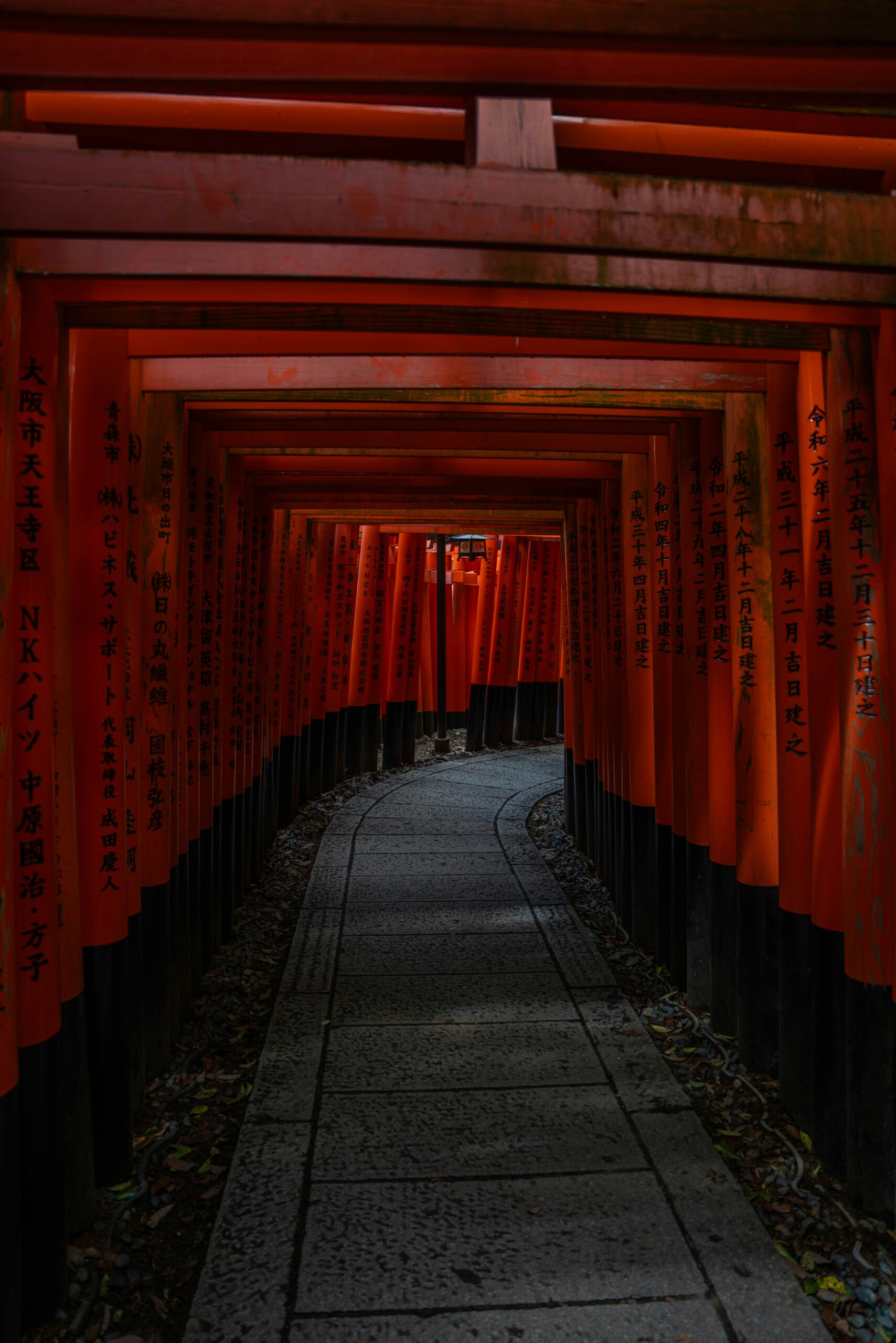Spectacular view of thousands of vermilion torii gate tunnels at Fushimi Inari Taisha shrine in Kyoto, Japan, showcasing the famous walking path through traditional Japanese shrine architecture