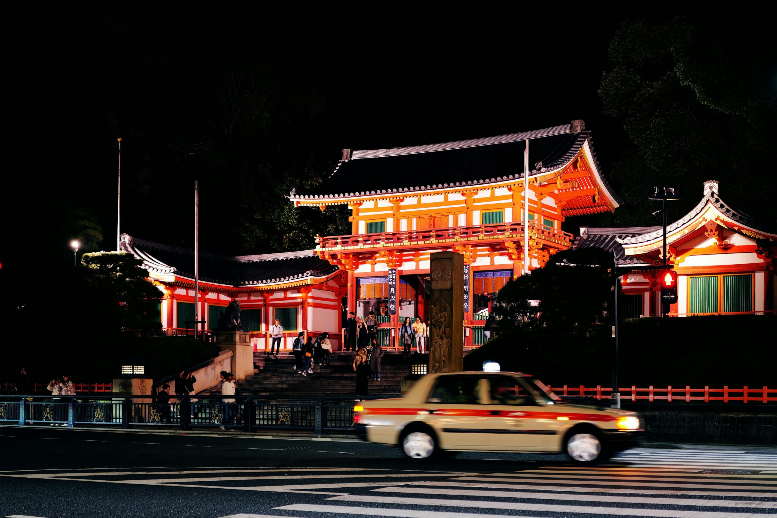 Traditional Japanese paper lanterns glowing warmly along stone pathway during autumn festival creating atmospheric night scene in Kyoto streets
