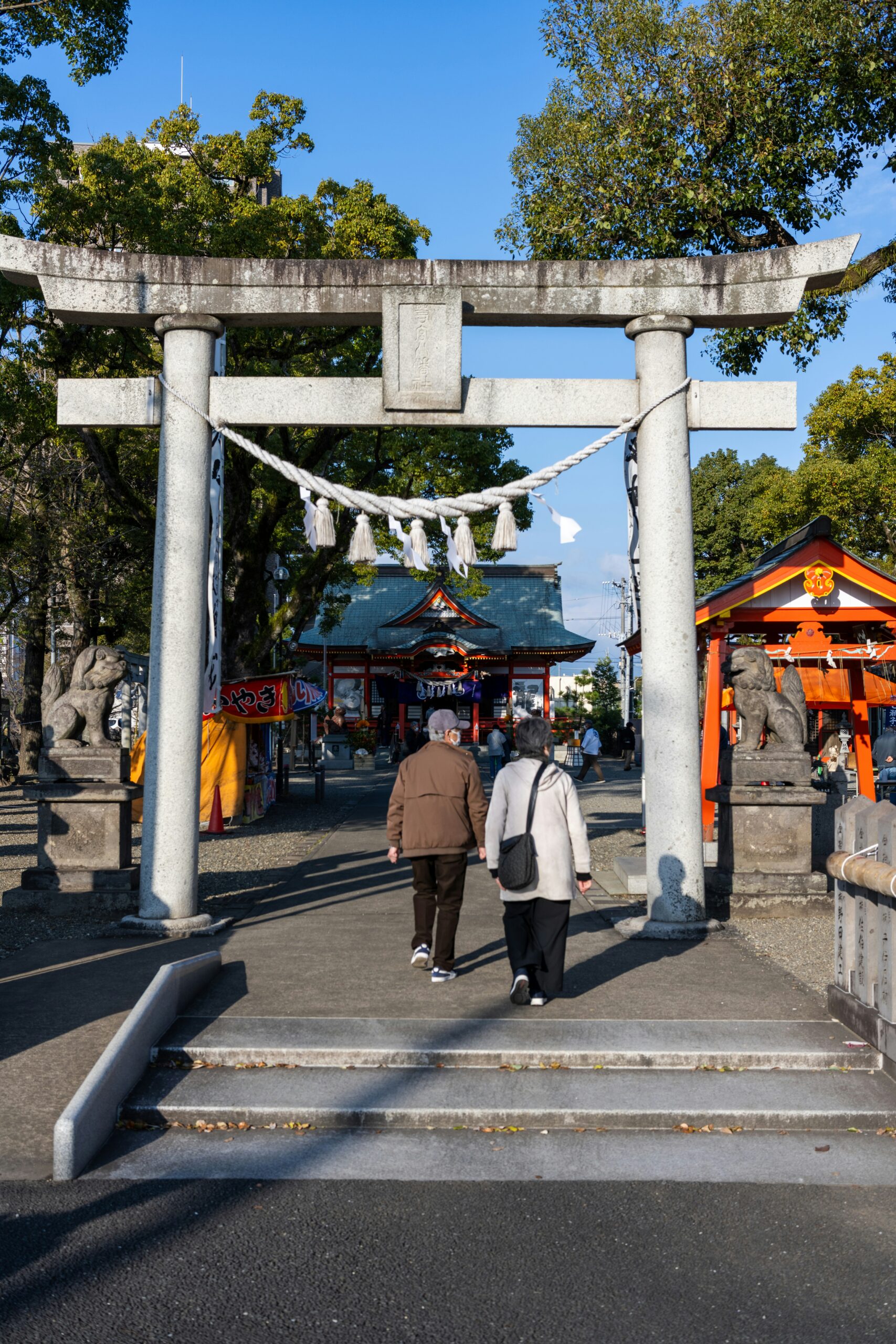 Endless tunnel of vermillion red torii gates creating a mystical pathway through Mount Inari forest at Fushimi Inari Taisha shrine Kyoto
