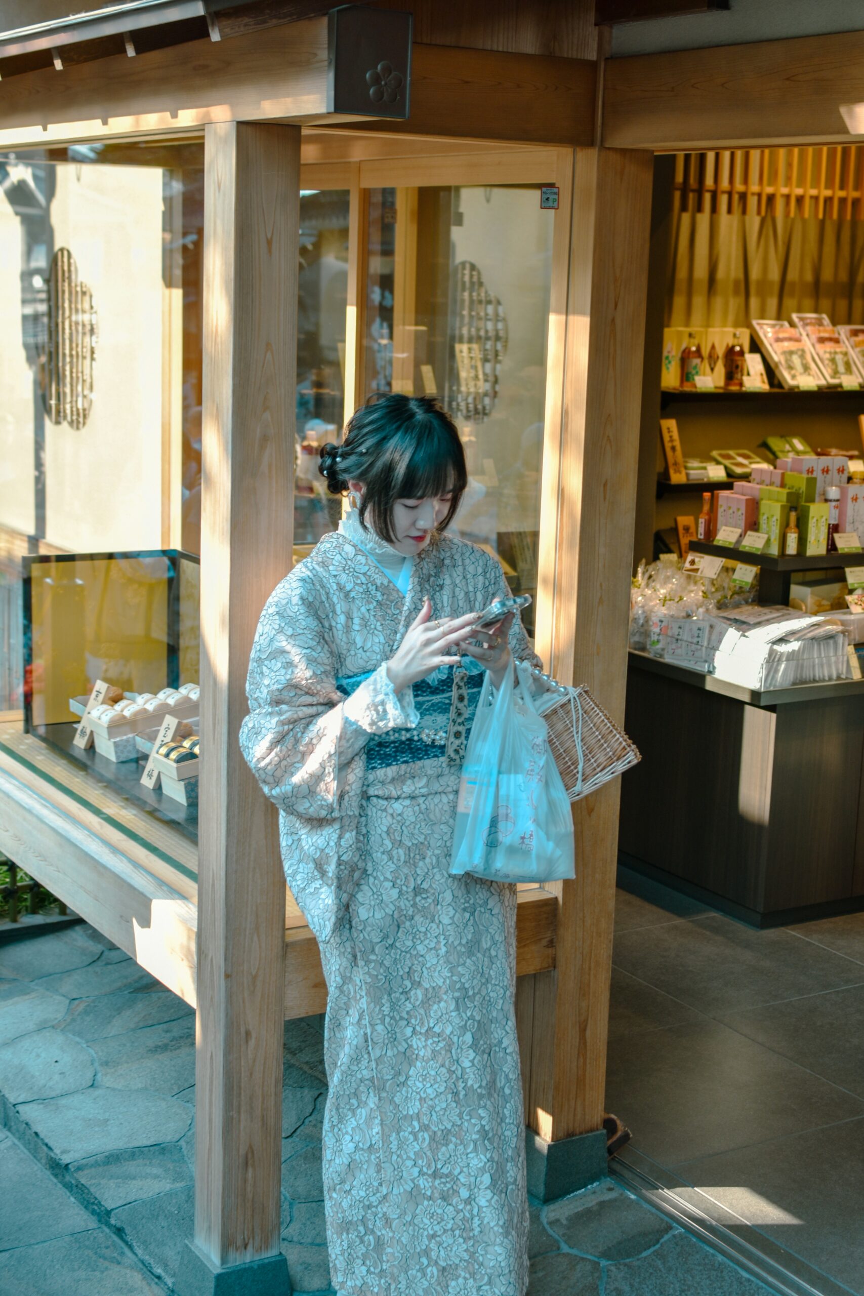Happy tourist in traditional kimono enjoying professional photography session at Kyoto shrine capturing authentic Japanese cultural experience and travel memories