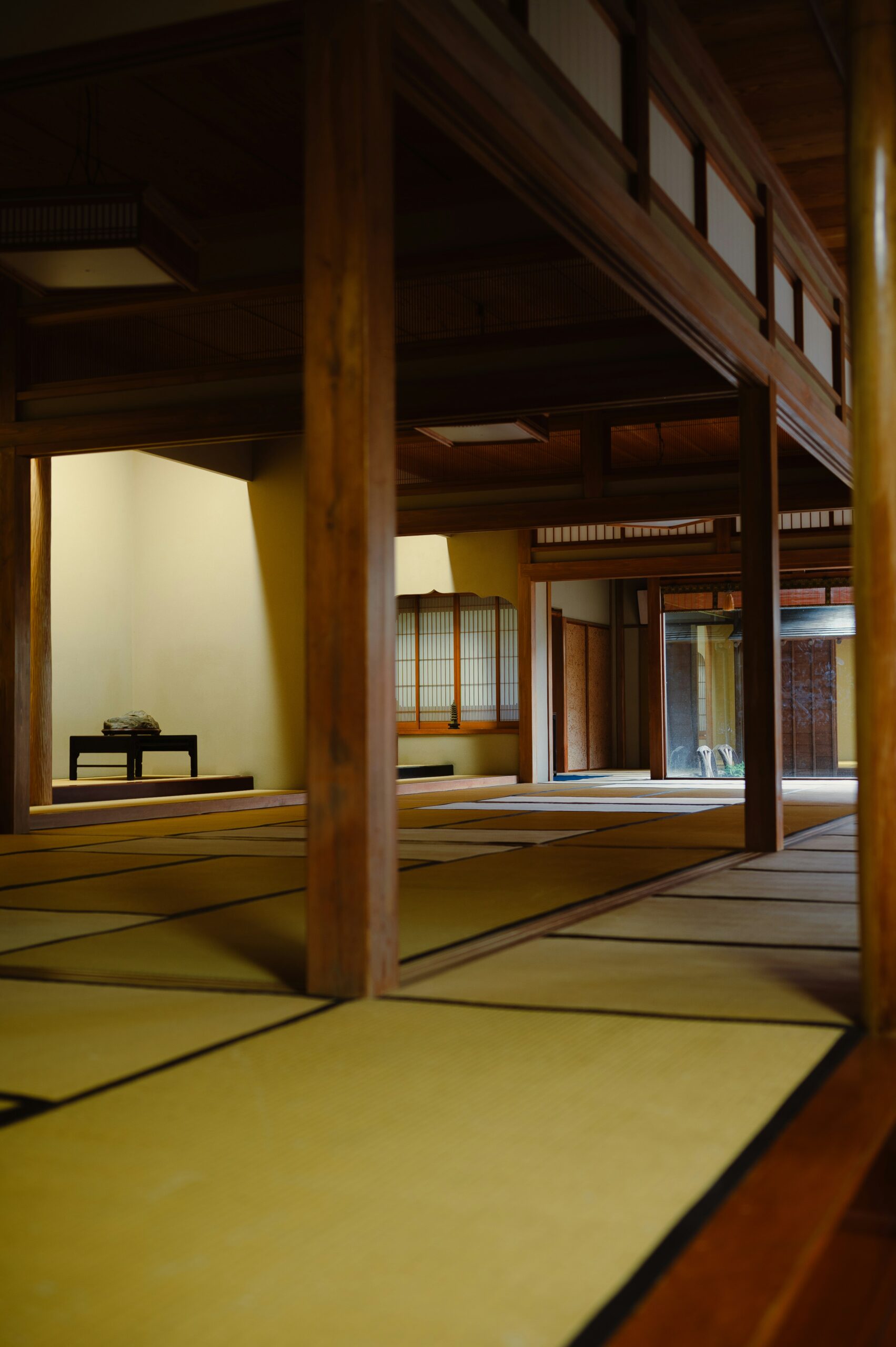 Traditional Japanese stone lantern path lined with moss-covered lanterns creating mystical atmosphere in temple grounds
