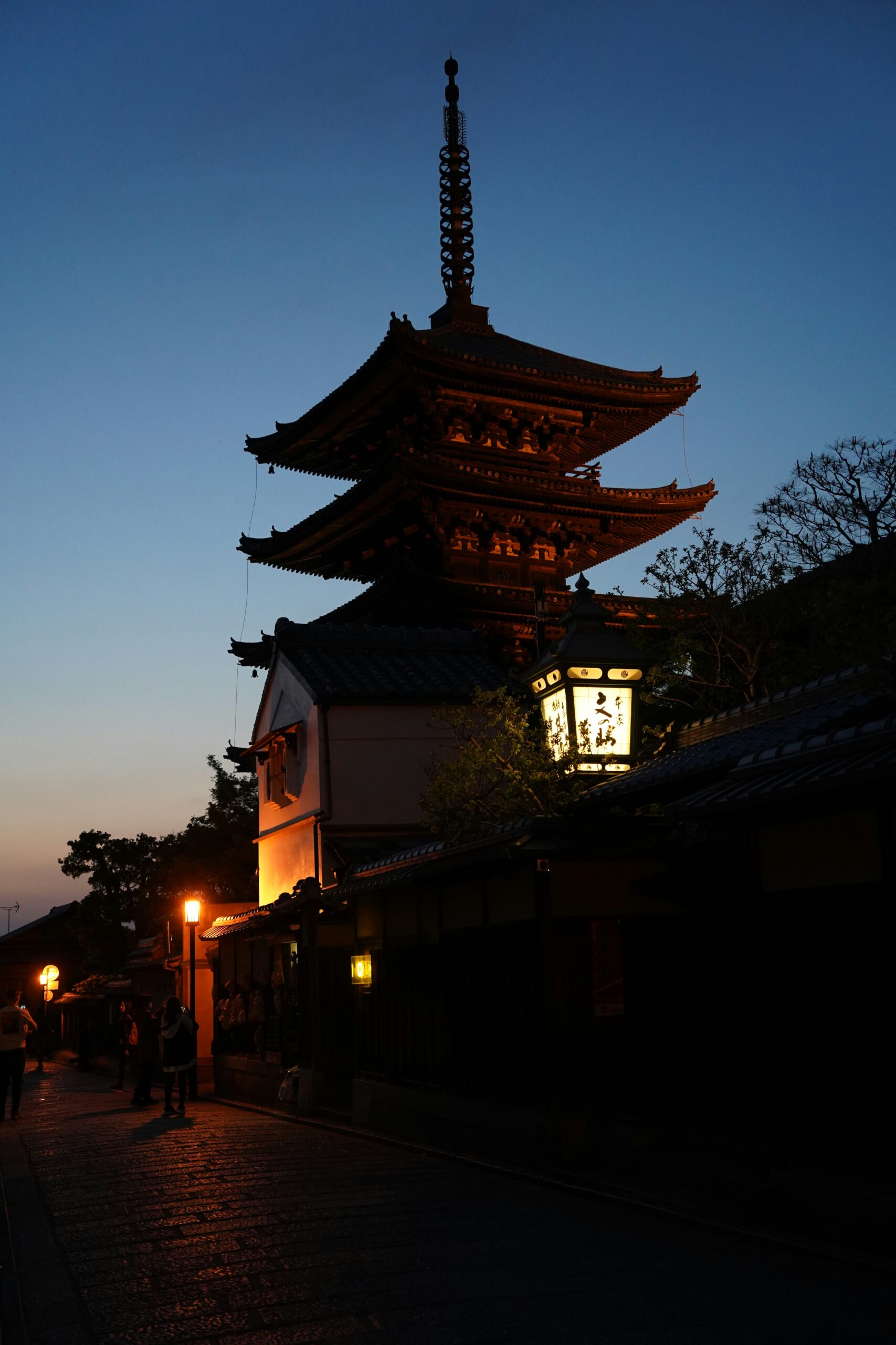 Professional kimono photo shoot of couple on traditional Japanese bridge in Kanazawa during golden hour with photographer capturing romantic moments