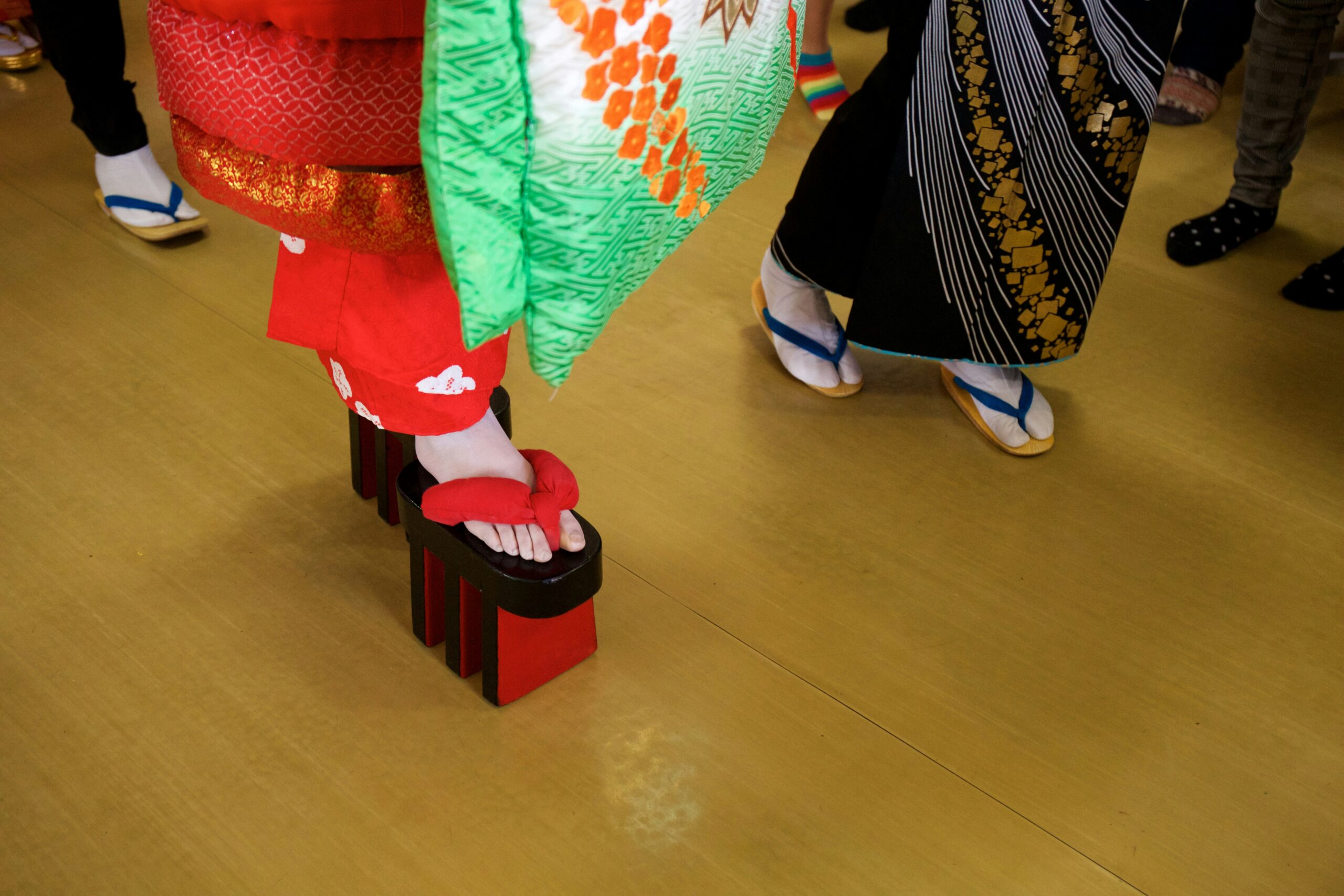 Close-up detail of traditional kimono obi sash with intricate floral patterns and silk fabric showcasing Japanese craftsmanship