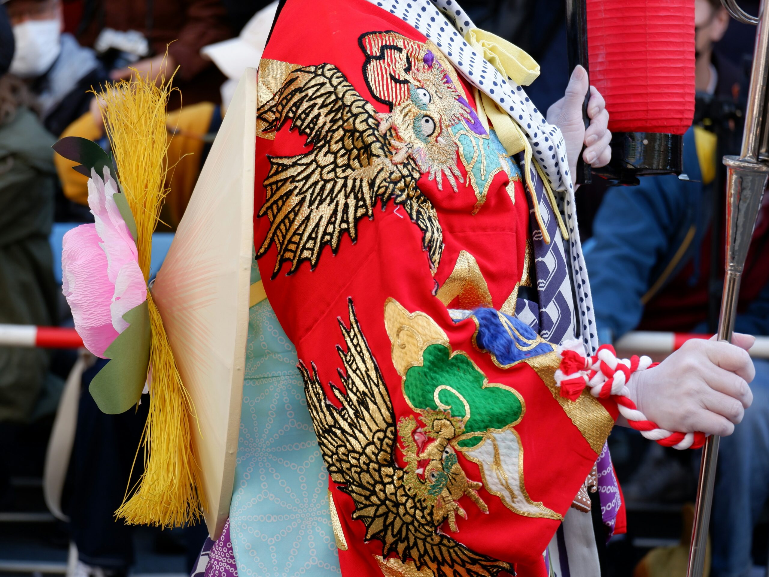 Close-up detail of traditional Japanese kimono fabric with decorative obi belt showing intricate patterns and authentic Japanese textile craftsmanship