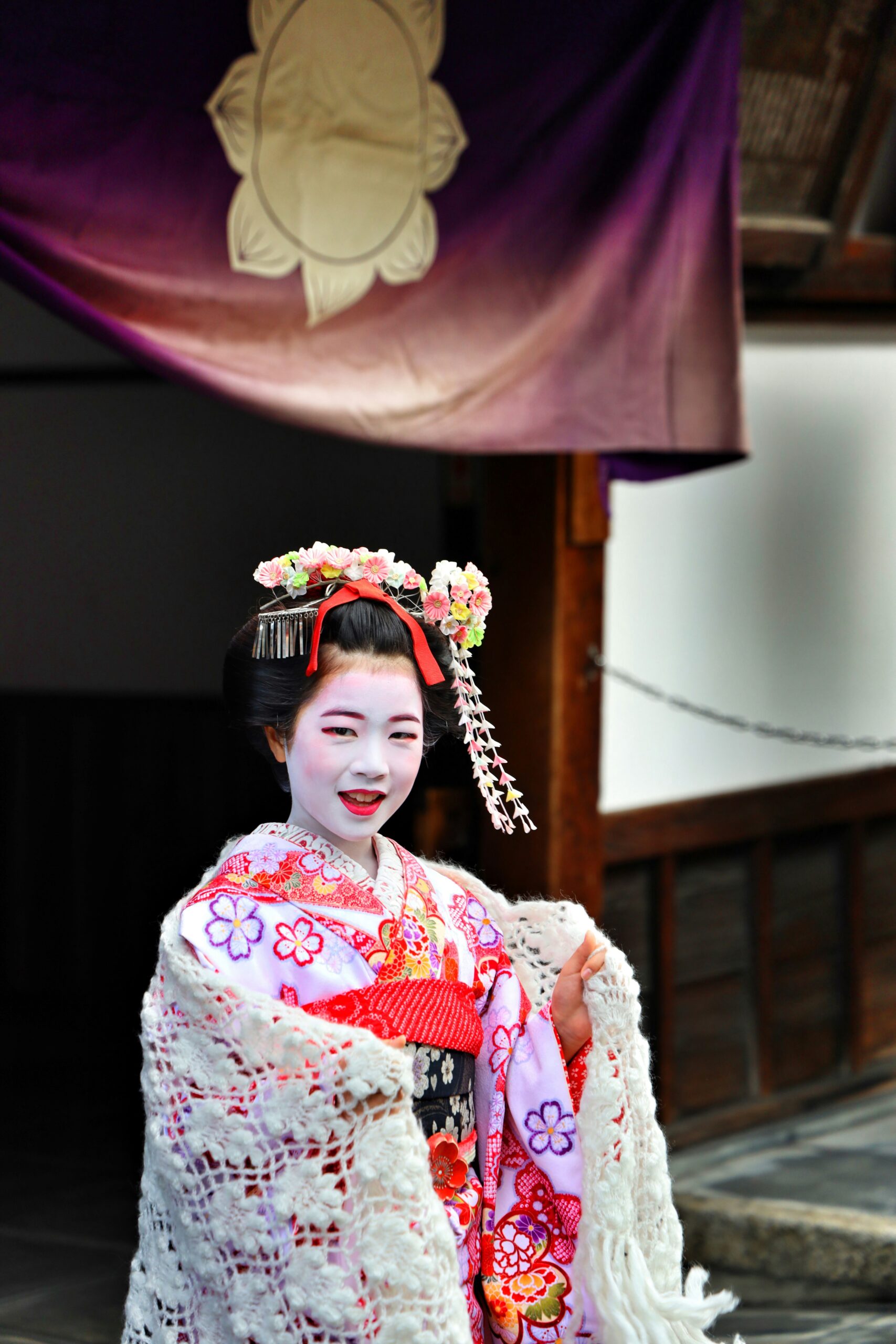 Traditional Japanese maiko performing elegant dance in ornate kimono at Kyoto cultural performance