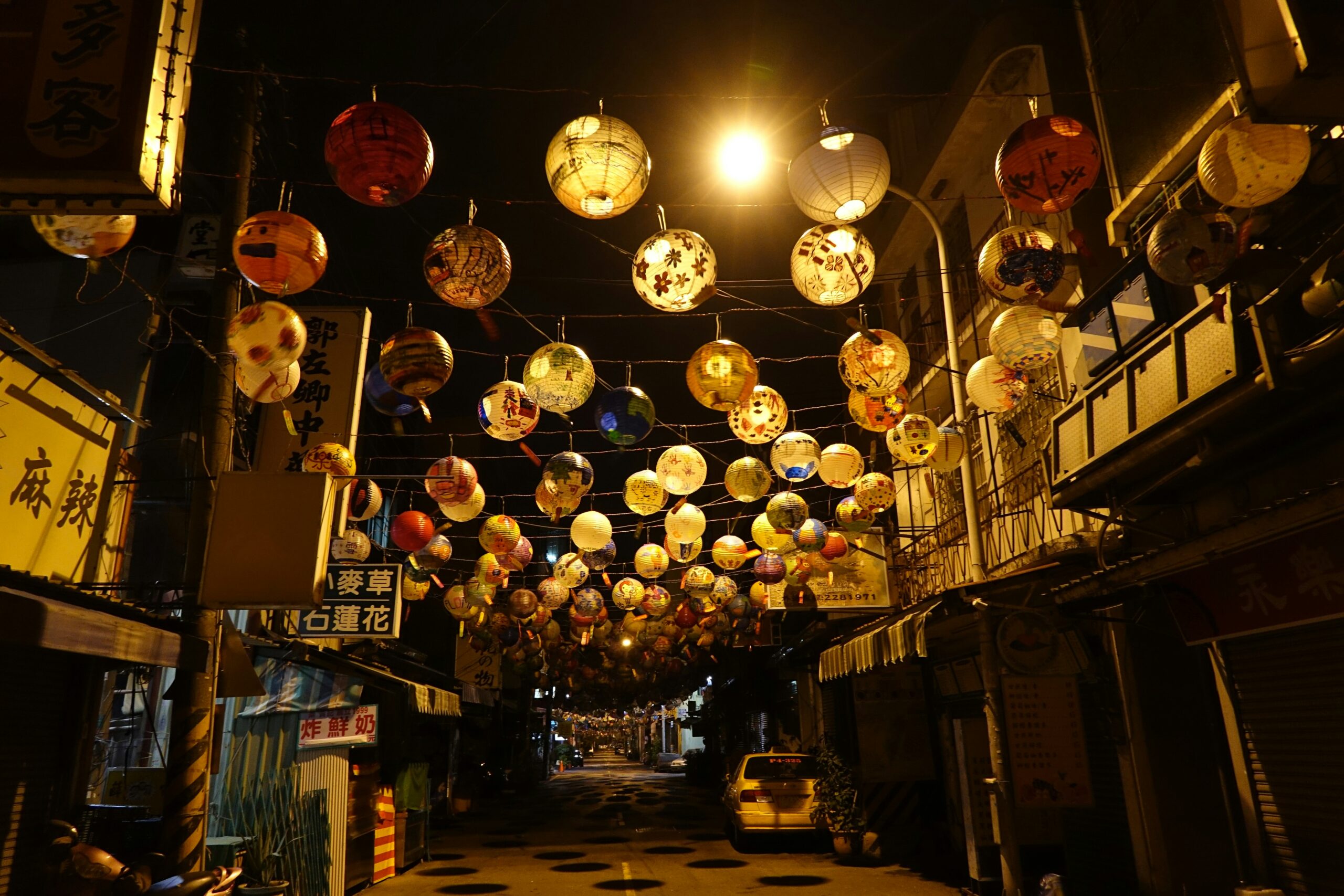 Elegant women in traditional Japanese kimonos walking through illuminated lantern pathways during Kyoto autumn festival at night