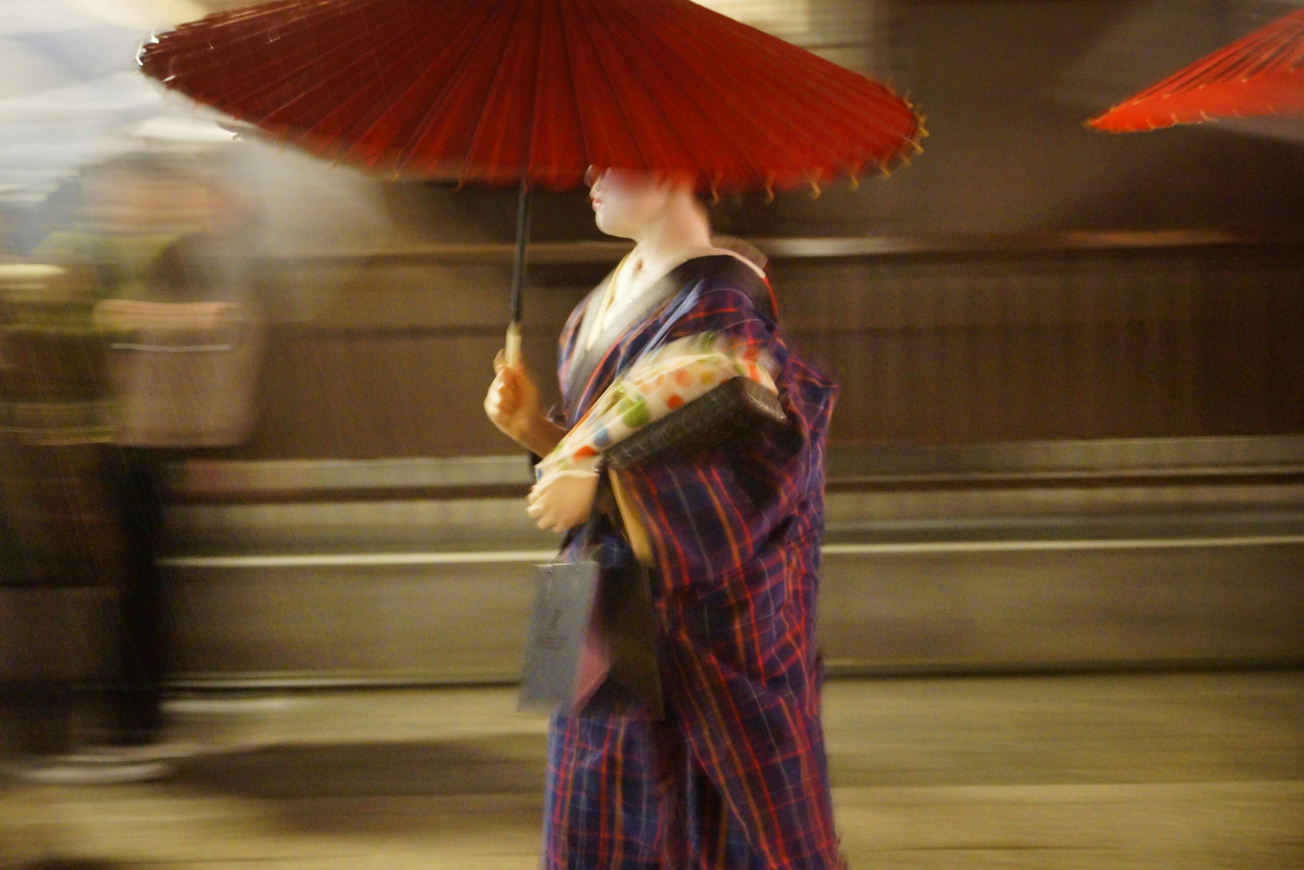 Close-up of traditional red wagasa umbrella showing intricate bamboo ribs and hand-painted Japanese paper craftsmanship