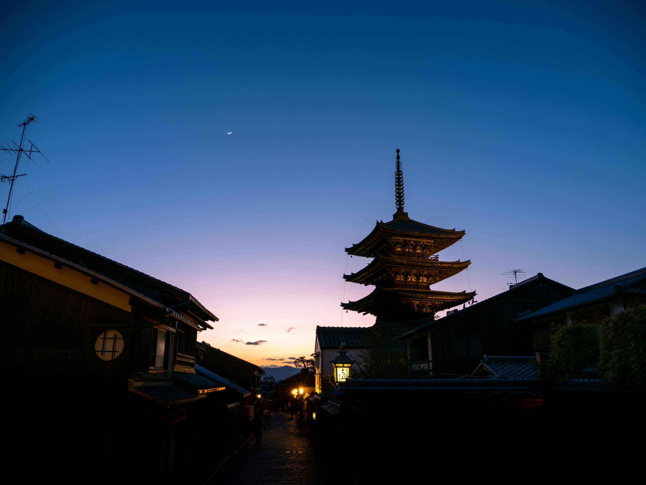 Hidden temple pathway in Kyoto with traditional stone lanterns, moss-covered steps, and peaceful morning atmosphere away from tourist crowds